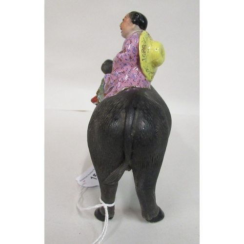 154 - An early to mid 20thC Chinese famille rose porcelain figure, a traditionally attired, smiling boy, a... 