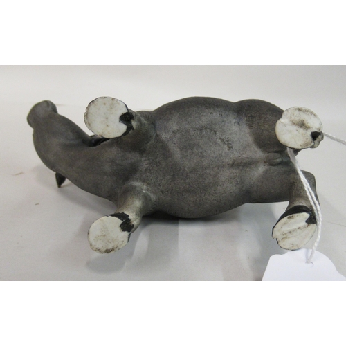 154 - An early to mid 20thC Chinese famille rose porcelain figure, a traditionally attired, smiling boy, a... 