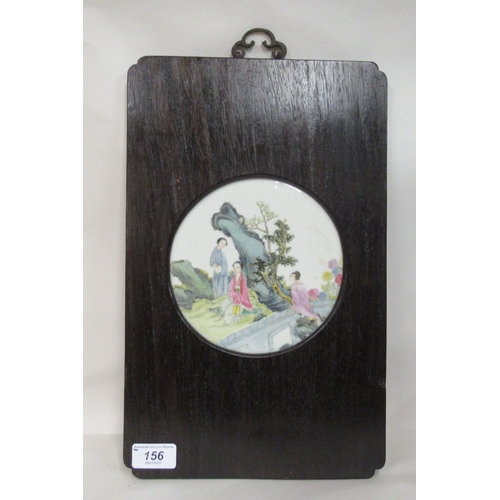156 - An early 20thC Chinese porcelain panel, decorated in famille rose with conversational figures, befor... 