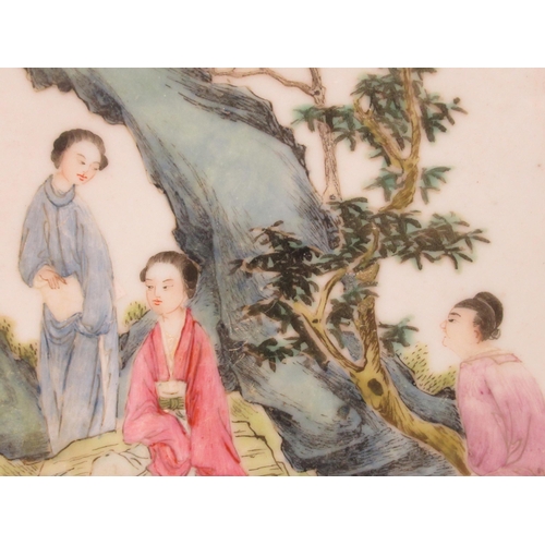 156 - An early 20thC Chinese porcelain panel, decorated in famille rose with conversational figures, befor... 