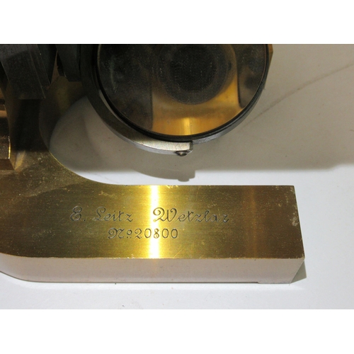 157 - A late 19thC E Leitz Wetzlar, no.20800, lacquered brass microscope with three rotating lenses and at... 