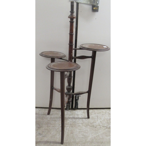 168 - An Edwardian mahogany three tier cake stand, raised on splayed legs  37