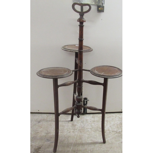 168 - An Edwardian mahogany three tier cake stand, raised on splayed legs  37