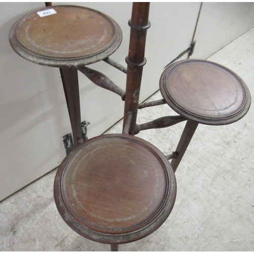 168 - An Edwardian mahogany three tier cake stand, raised on splayed legs  37