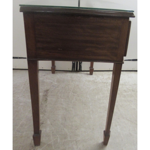 172 - An early 20thC mahogany bow front, two drawer sideboard, raised on square, tapered legs and spade fe... 