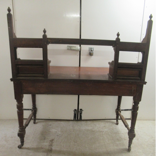 173 - An Edwardian mahogany dresser with an arrangement of open shelves and drawers, over two frieze drawe... 