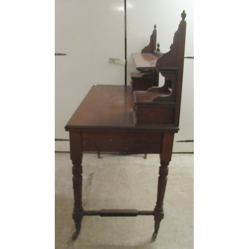 173 - An Edwardian mahogany dresser with an arrangement of open shelves and drawers, over two frieze drawe... 