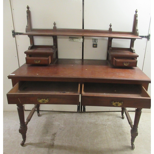 173 - An Edwardian mahogany dresser with an arrangement of open shelves and drawers, over two frieze drawe... 