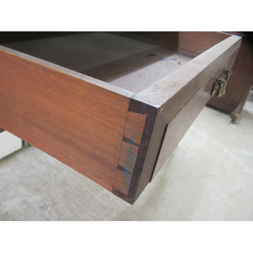 173 - An Edwardian mahogany dresser with an arrangement of open shelves and drawers, over two frieze drawe... 