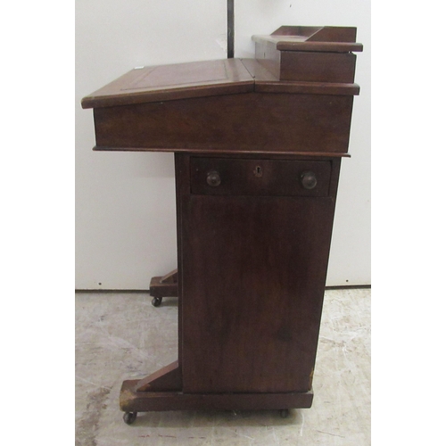 174 - A late Victorian mahogany Davenport with a hinged red hide scriber, over a panelled door, on a plint... 