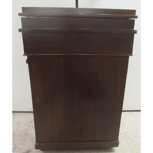 174 - A late Victorian mahogany Davenport with a hinged red hide scriber, over a panelled door, on a plint... 