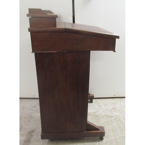 174 - A late Victorian mahogany Davenport with a hinged red hide scriber, over a panelled door, on a plint... 