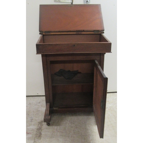 174 - A late Victorian mahogany Davenport with a hinged red hide scriber, over a panelled door, on a plint... 