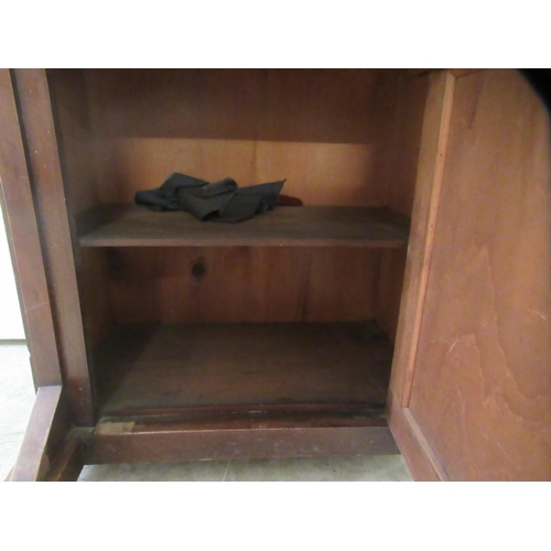 174 - A late Victorian mahogany Davenport with a hinged red hide scriber, over a panelled door, on a plint... 