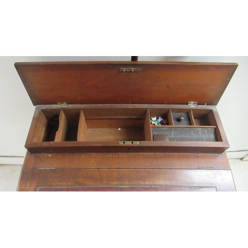 174 - A late Victorian mahogany Davenport with a hinged red hide scriber, over a panelled door, on a plint... 