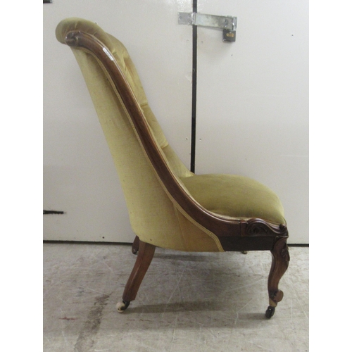 176 - A late Victorian rosewood showwood framed nursing chair, the part buttoned, old gold coloured fabric... 