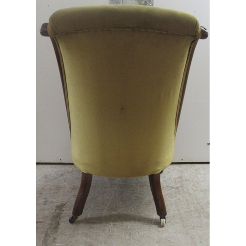176 - A late Victorian rosewood showwood framed nursing chair, the part buttoned, old gold coloured fabric... 