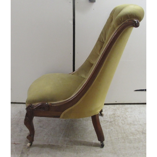 176 - A late Victorian rosewood showwood framed nursing chair, the part buttoned, old gold coloured fabric... 