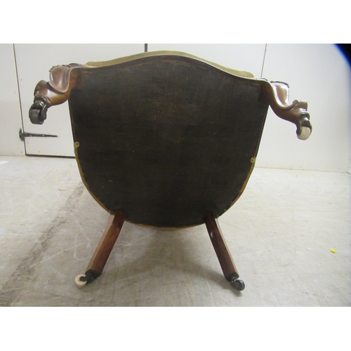 176 - A late Victorian rosewood showwood framed nursing chair, the part buttoned, old gold coloured fabric... 