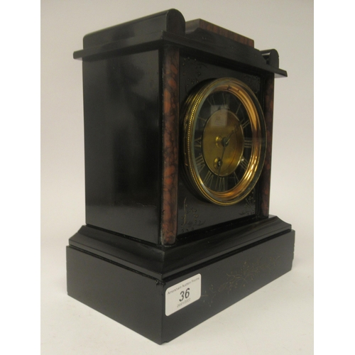 36 - A late 19thC black slate and mottled iron red marble cased mantel timepiece with a platform top; the... 