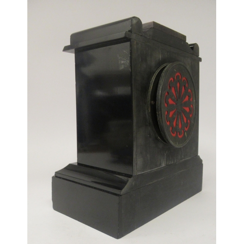 36 - A late 19thC black slate and mottled iron red marble cased mantel timepiece with a platform top; the... 