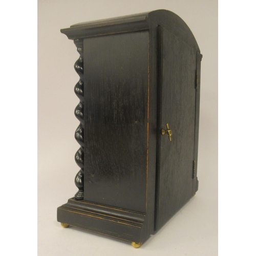 58 - A late 19th/early 20thC stained oak cased, round arched mantel timepiece; the 8 day Astral movement ... 