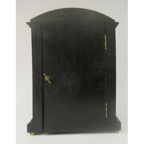 58 - A late 19th/early 20thC stained oak cased, round arched mantel timepiece; the 8 day Astral movement ... 