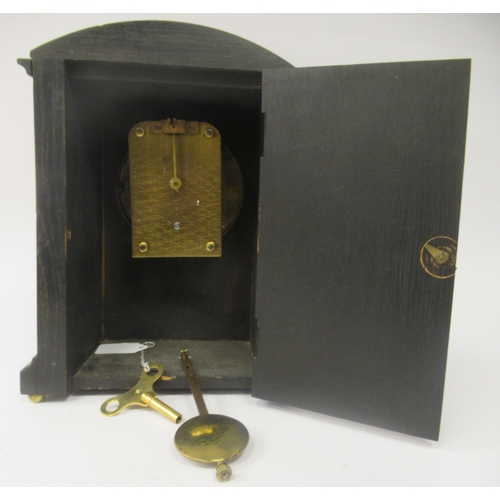 58 - A late 19th/early 20thC stained oak cased, round arched mantel timepiece; the 8 day Astral movement ... 