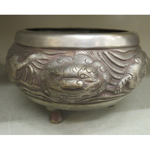 133 - A 19thC South East Asian Paktong censer of squat, bulbous form with opposing dragon handles, elevate... 