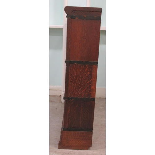 258 - An early 20thC oak, three section Globe Wernicke bookcase with rising glazed doors, on a plinth&nbsp... 