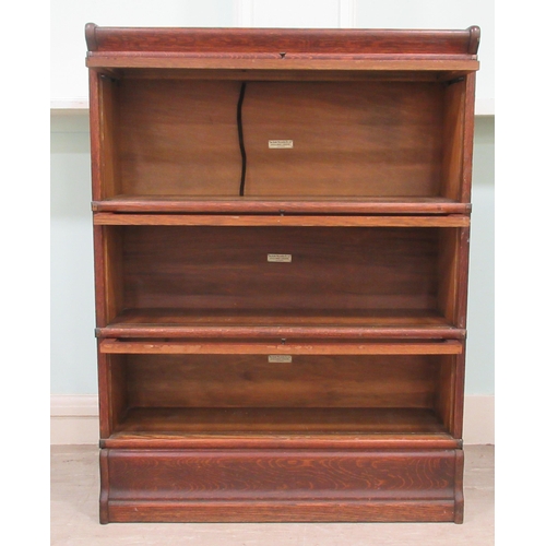 258 - An early 20thC oak, three section Globe Wernicke bookcase with rising glazed doors, on a plinth&nbsp... 