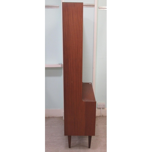 259 - A 1960s/70s teak living room unit with an arrangement of open shelves, doors and a fall flap, raised... 