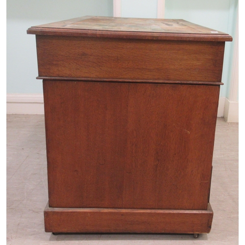 261 - An Edwardian oak twin pedestal desk with an arrangement of nine drawers, on a plinth&nbsp; 30