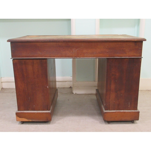 261 - An Edwardian oak twin pedestal desk with an arrangement of nine drawers, on a plinth&nbsp; 30