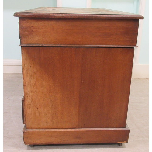 261 - An Edwardian oak twin pedestal desk with an arrangement of nine drawers, on a plinth&nbsp; 30