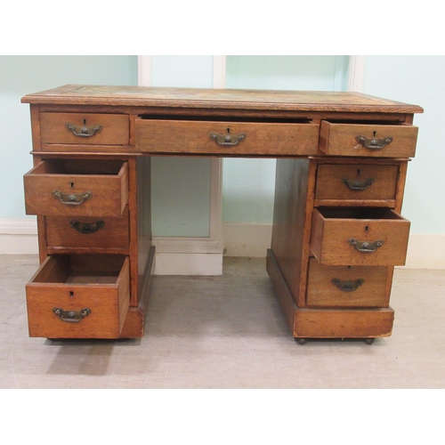 261 - An Edwardian oak twin pedestal desk with an arrangement of nine drawers, on a plinth&nbsp; 30
