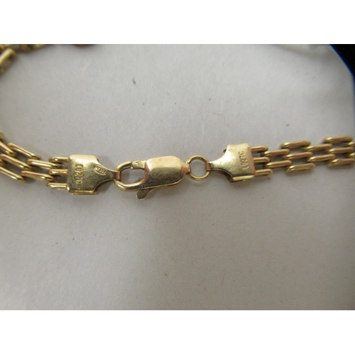 29 - A gold coloured metal gate link bracelet, set with white and coloured stones  stamped 750