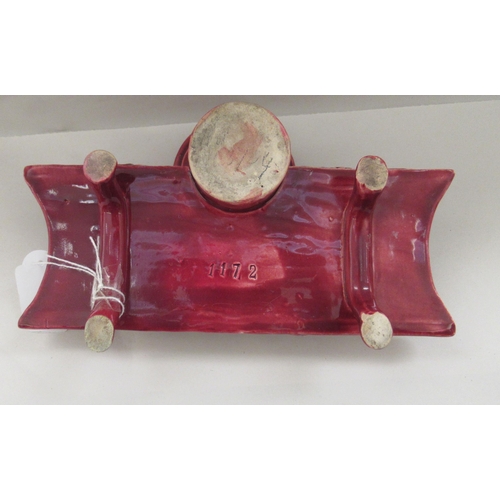 20 - A late 19thC majolica floral decorated and damsen glazed earthenware inkstand, ornamented with a ser... 