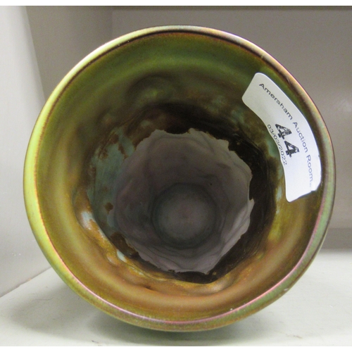 44 - A Continental green/gold lustre glazed china beaker vase, decorated with standing maidens  6.25