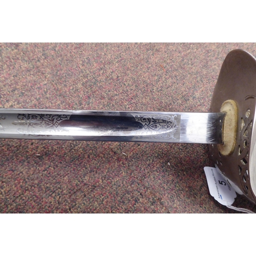 5 - A George VI military dress sword with a wire bound, shagreen handgrip, basket hilt and engraved blad... 
