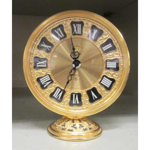 113 - A Jaeger gilt metal barrel clock; the 8 day movement faced by a Roman dial with an alarm  4