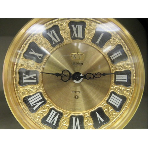 113 - A Jaeger gilt metal barrel clock; the 8 day movement faced by a Roman dial with an alarm  4