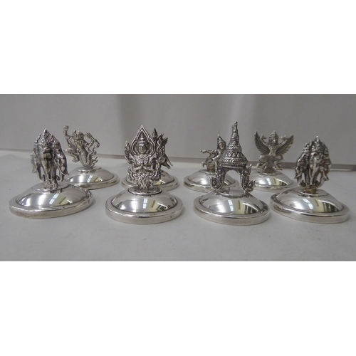 146 - A set of twelve Thai Sterling silver place setting card holders, fashioned as animals, buildings and... 