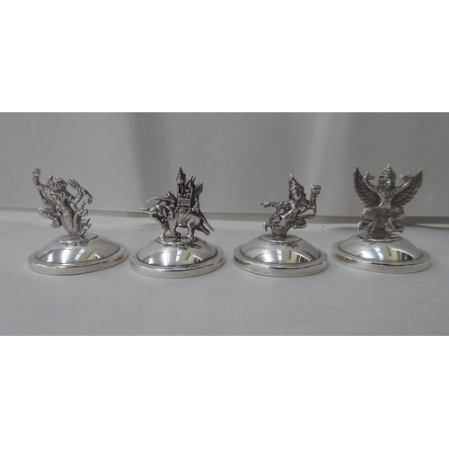 146 - A set of twelve Thai Sterling silver place setting card holders, fashioned as animals, buildings and... 