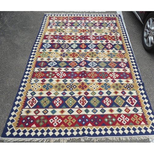 149 - Two rugs: to include an Aztec design example with geometric motifs, on a multi-coloured ground  82