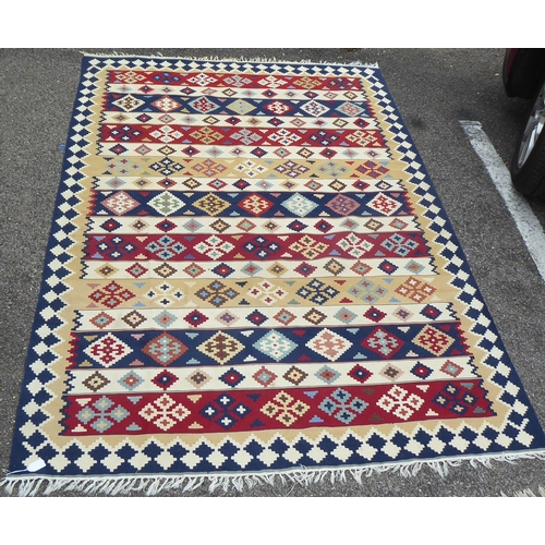 149 - Two rugs: to include an Aztec design example with geometric motifs, on a multi-coloured ground  82