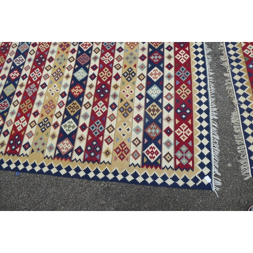 149 - Two rugs: to include an Aztec design example with geometric motifs, on a multi-coloured ground  82