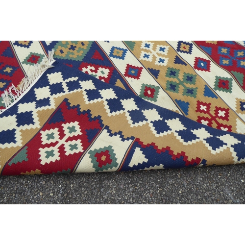 149 - Two rugs: to include an Aztec design example with geometric motifs, on a multi-coloured ground  82