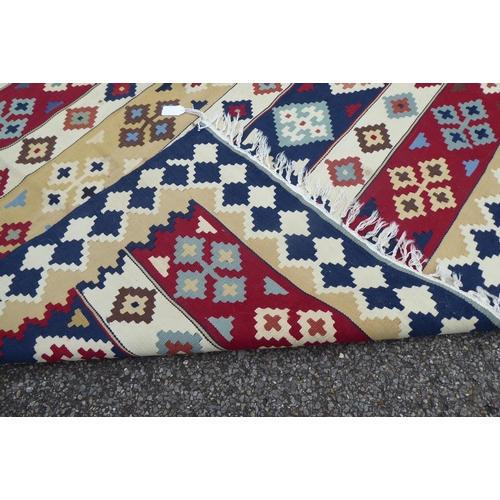 149 - Two rugs: to include an Aztec design example with geometric motifs, on a multi-coloured ground  82