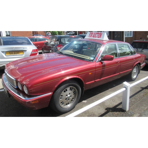 150 - A 1995 Jaguar Sovereign automatic 3.2ltr petrol, five door saloon in red livery with cream coloured ... 